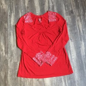 Long sleeve red and white embroidered shirt.